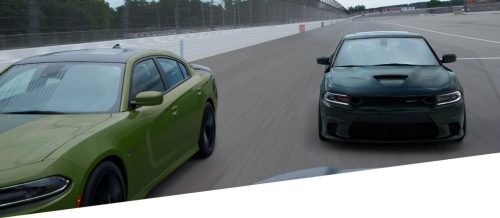 Green and black Dodge Charger on the track
